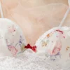 639755c1-eeee-435b-bb13-c4b0f0717619 Floral lace ruffle-trim bralette with adjustable straps paired with matching floral print sleep shorts on soft tulle backdrop.
