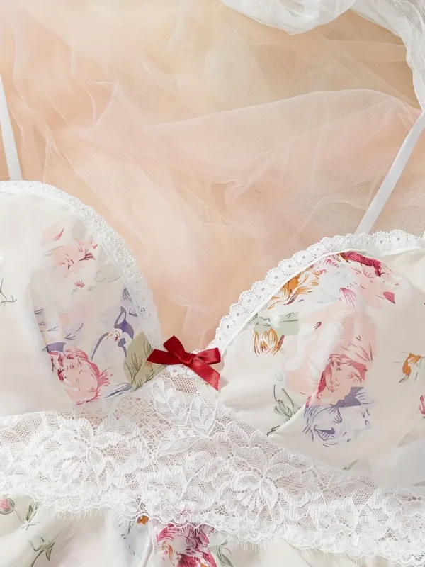 639755c1-eeee-435b-bb13-c4b0f0717619 Floral lace ruffle-trim bralette with adjustable straps paired with matching floral print sleep shorts on soft tulle backdrop.